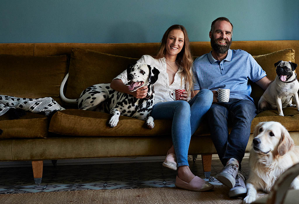 Couple on lounge with their dogs