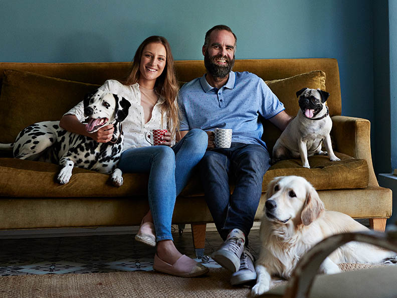 Couple on lounge with their dogs