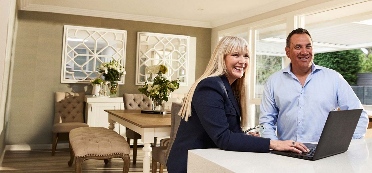 kerri anne turner sitting with partner at kitchen bench on laptop