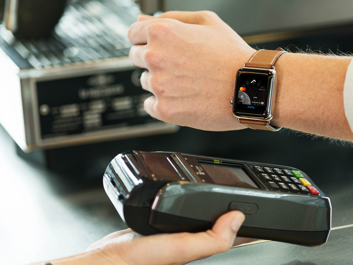 Man paying at EFTPOS machine with Machine card using apple watch