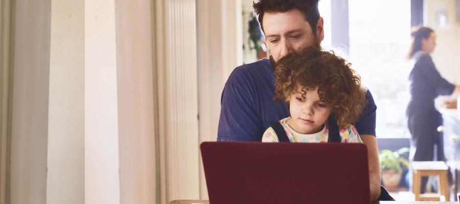 Image of a man and a child looking at a laptop