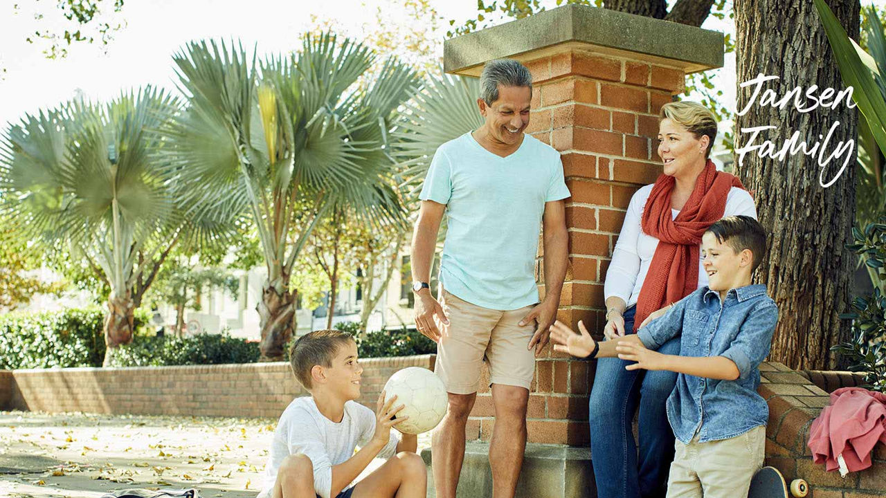 Jansen family home loan customer with kids outside in park playing and talking